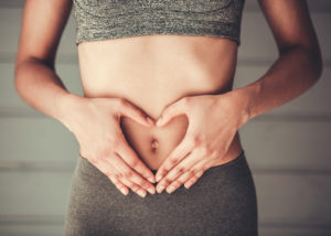 Girl doing sport with hands on her stomach