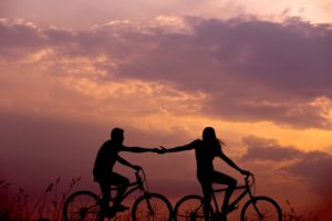 couple bike riding during sunset