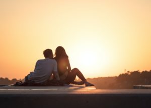 couple on dock during sunset